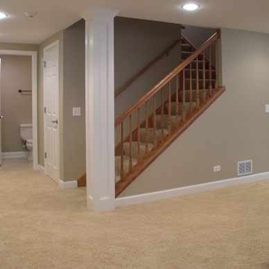 finished basement with tan walls and beige carpet