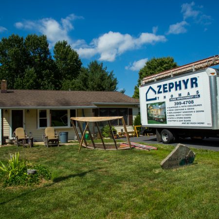 zephyr thomas truck and old windows in front of newly installed replacement windows