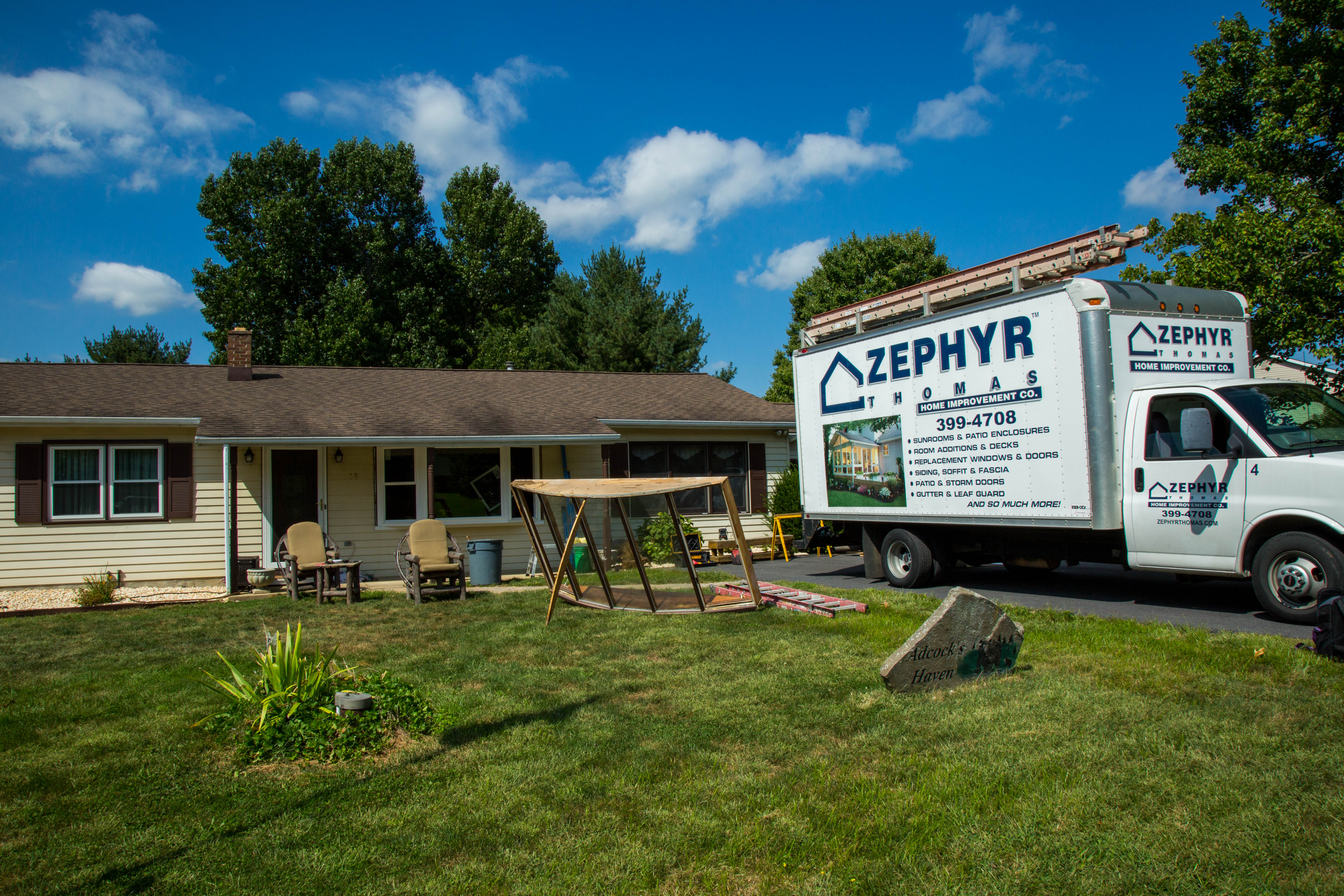 zephyr thomas truck and old windows in front of newly installed replacement windows