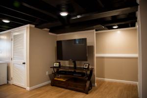 Silva - entertainment center in finished basement with hardwood floor