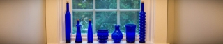 blue glass bottles on the ledge of a new window