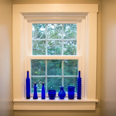 blue glass bottles along a window sill