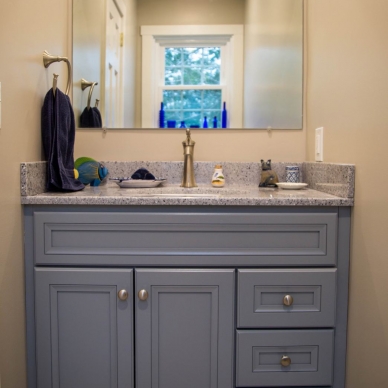 bathroom vanity with gray cabinets and countertop