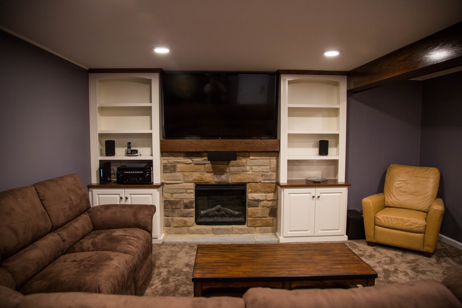 finished basement with fireplace and entertainment center