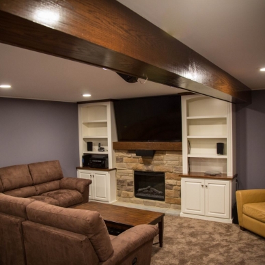 finished basement with fireplace and entertainment center