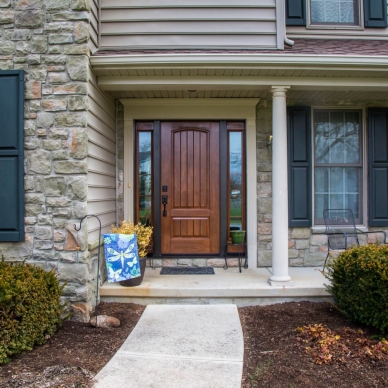 wooden front door with side windows