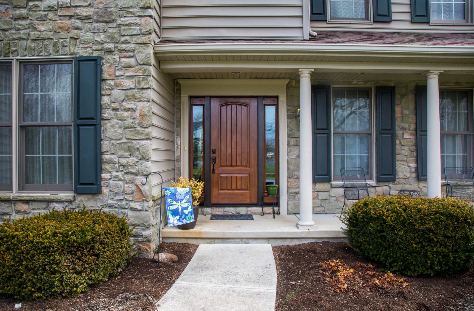 wooden front door with side windows