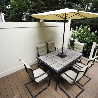 new deck with privacy fence and deck furniture