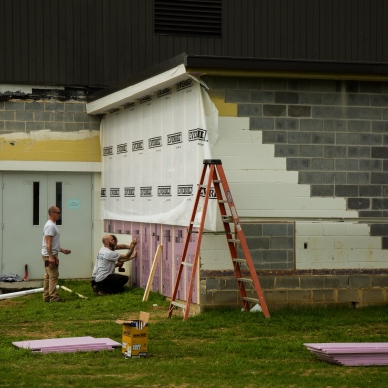 removing old concrete bricks and adding homewrap