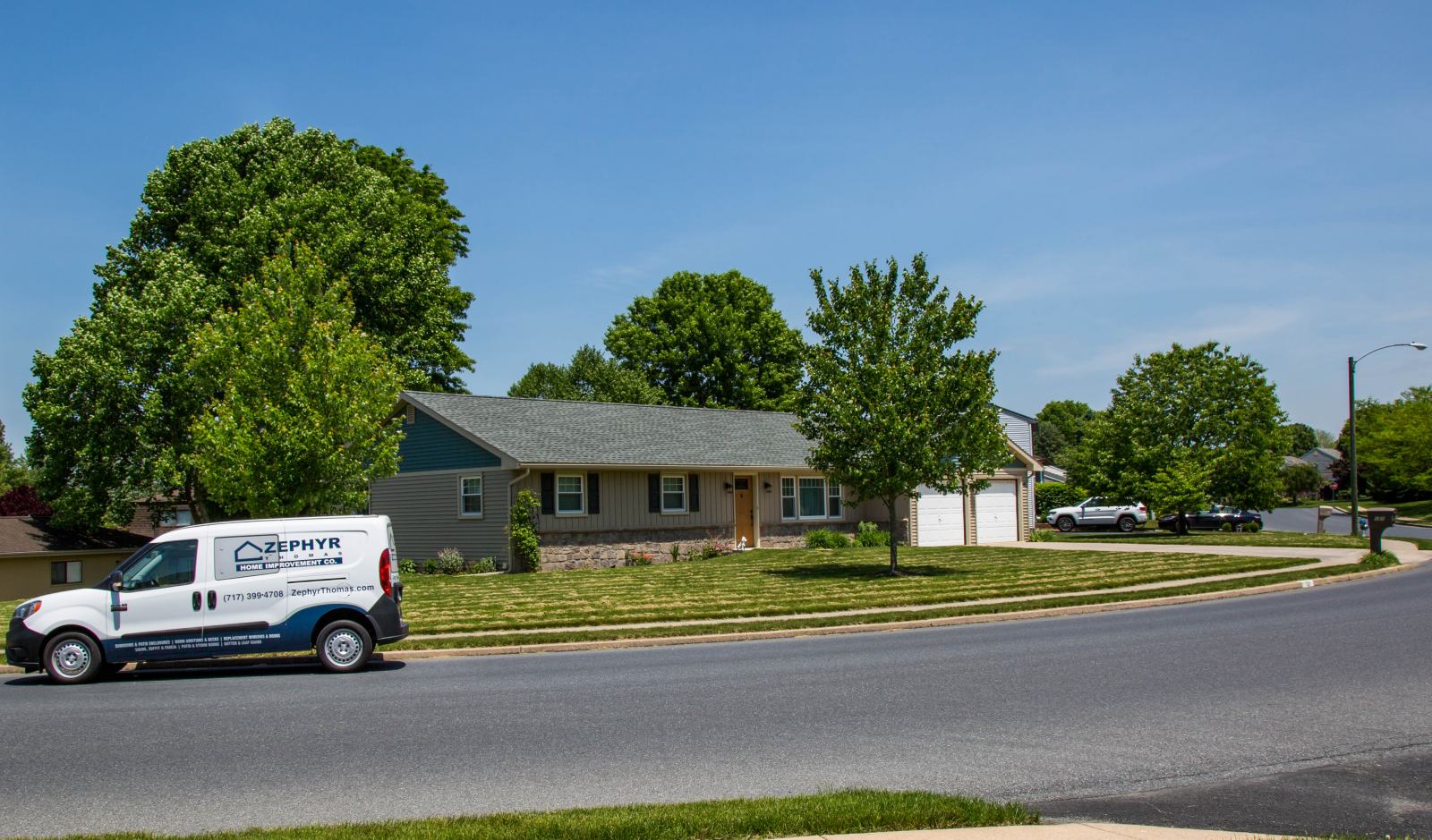 zephyr thomas van in front of house with new roof