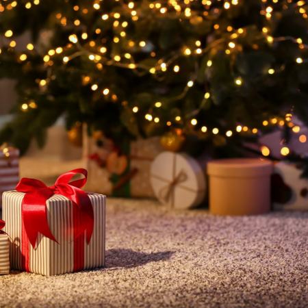 christmas presents on the floor under a tree