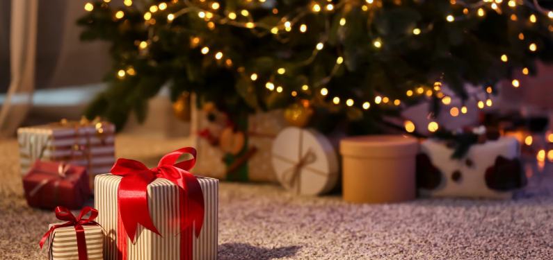 christmas presents on the floor under a tree