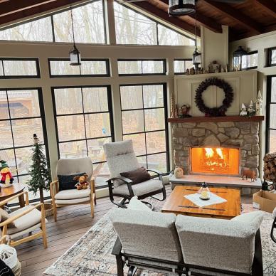 fireplace and furniture inside completed vertical 4-track room addition