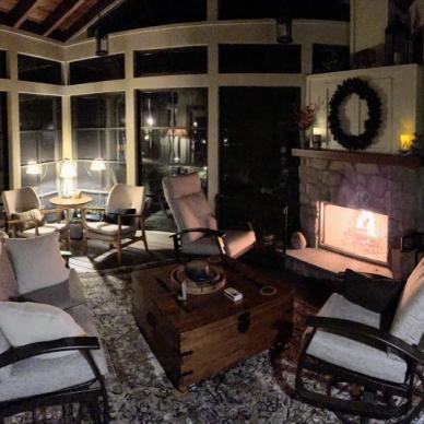 panoramic view of fireplace and furniture inside completed vertical 4-track room at night