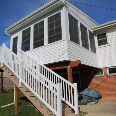McFarland - angled exterior view of second-story three-season room with staircase