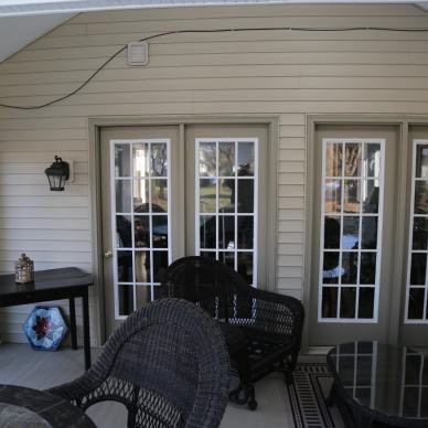 Thomas - sliding patio doors into house from inside three-season room