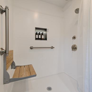 Menard - low-curb shower with built-in seat, bathroom grab bars, and built-in storage niche