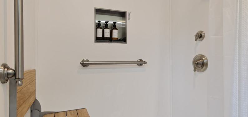 Menard - low-curb shower with built-in seat, bathroom grab bars, and built-in storage niche