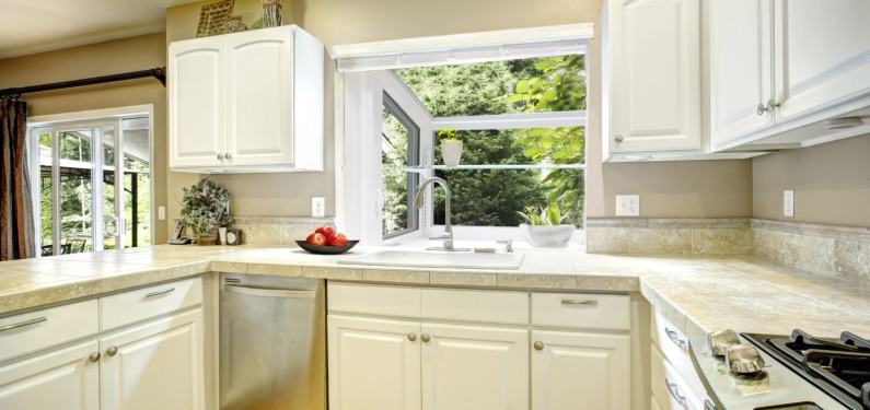 ProVia Endure garden window behind a kitchen sink in a kitchen with white cabinets
