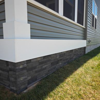 McKay enclosure - detail of stone siding on base of enclosure after a porch conversion to a 3-season room